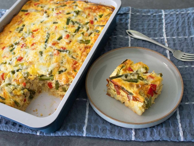 Golden Easter breakfast casserole with a slice removed