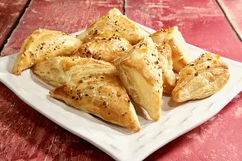 Bagel turnover garnished with sesame seeds and everything bagel seasoning