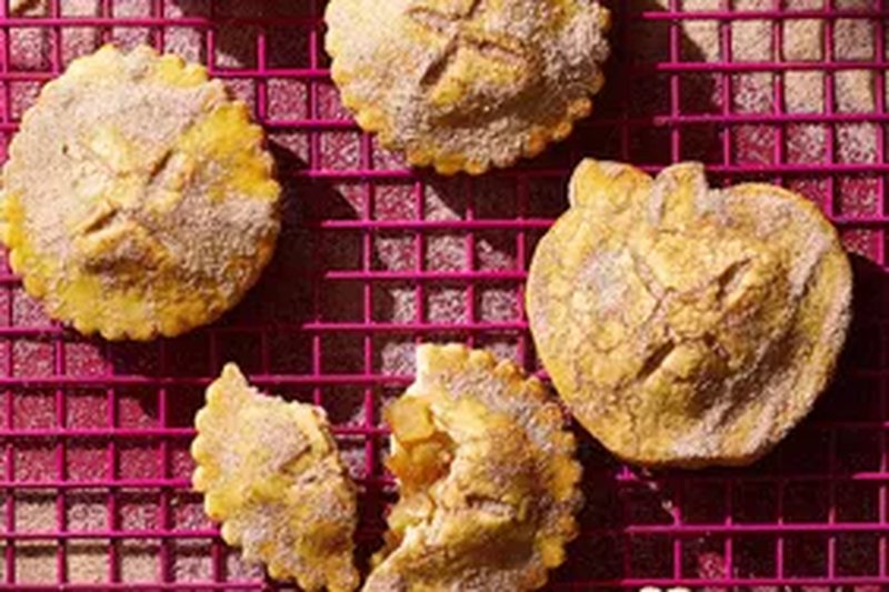 Baked pieshaped cookies on a cooling rack
