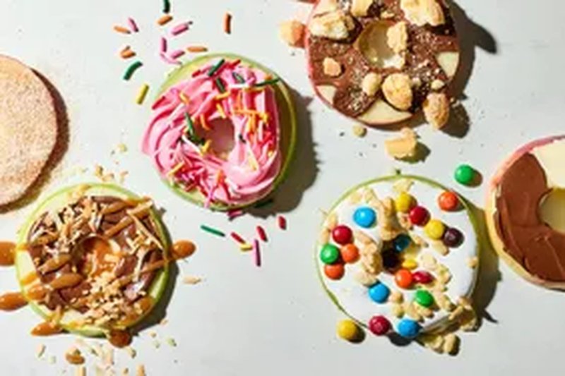 Decorated fruit dessert rings topped with candy and sprinkles