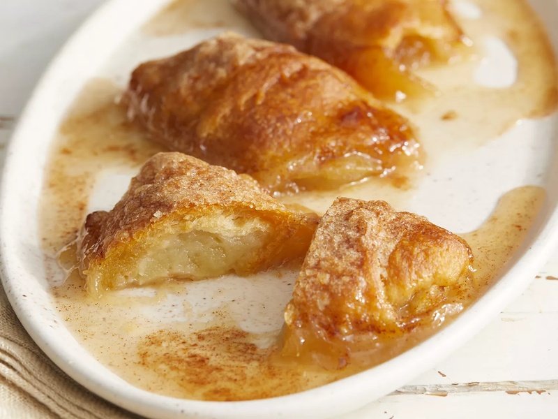 high angle looking at a plate of a few country apple dumplings with one cut in half