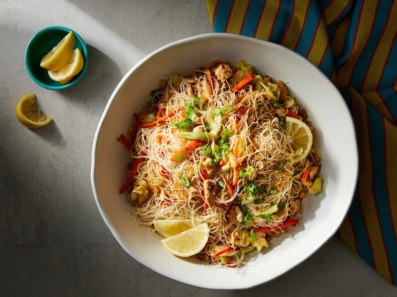 Pancit with chicken, vegetables, and rice noodles