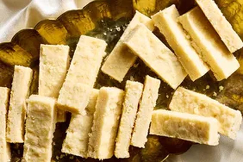 Several strips of homemade shortbread cookies on a gold platter