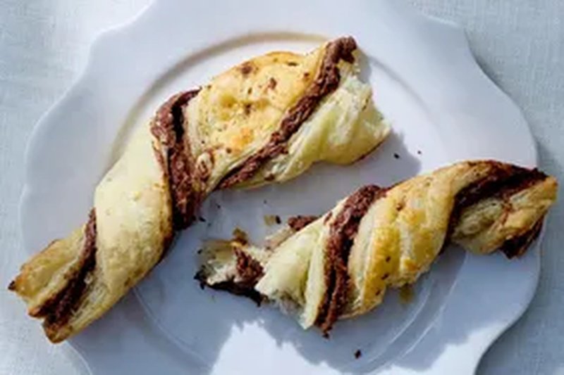 Two pastry twists with a chocolate filling on a plate