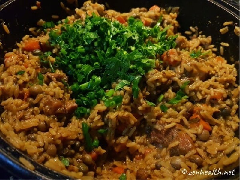 Mix in fresh herbs to Trinidad pelau