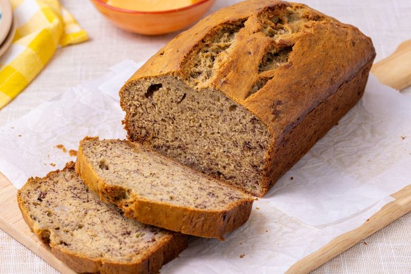 Sliced loaf of banana bread on parchment paper