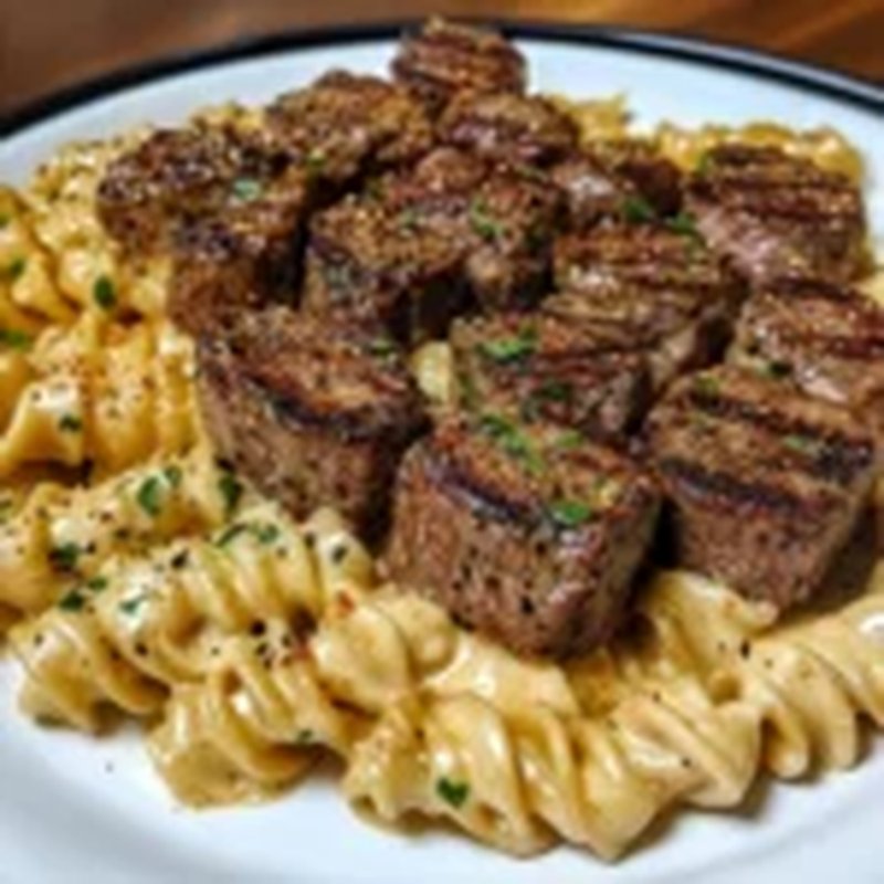 Creamy Garlic Butter Steak Bites with Spicy Cajun Alfredo Twisted Pasta